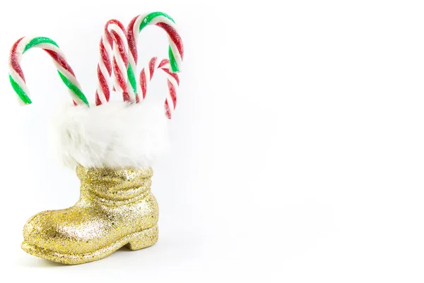 Bota dorada Santas con bastones aislados — Foto de Stock