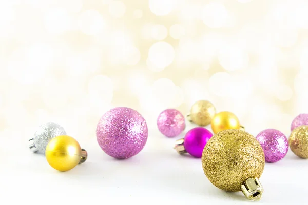 Various sized and colored Christmas balls with bokeh background — Stock Photo, Image