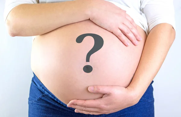 Pregnant woman belly with question mark — Stock Photo, Image