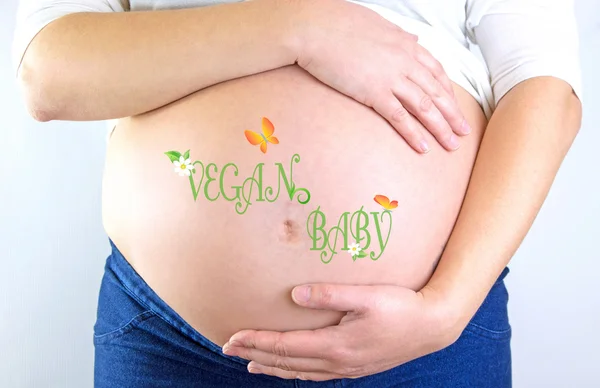 Pregnant woman belly with Vegan Baby text and illustration — Stock Photo, Image