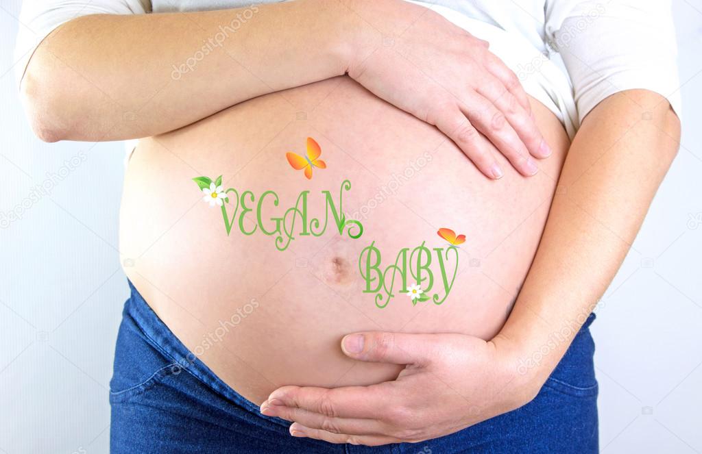 Pregnant woman belly with Vegan Baby text and illustration