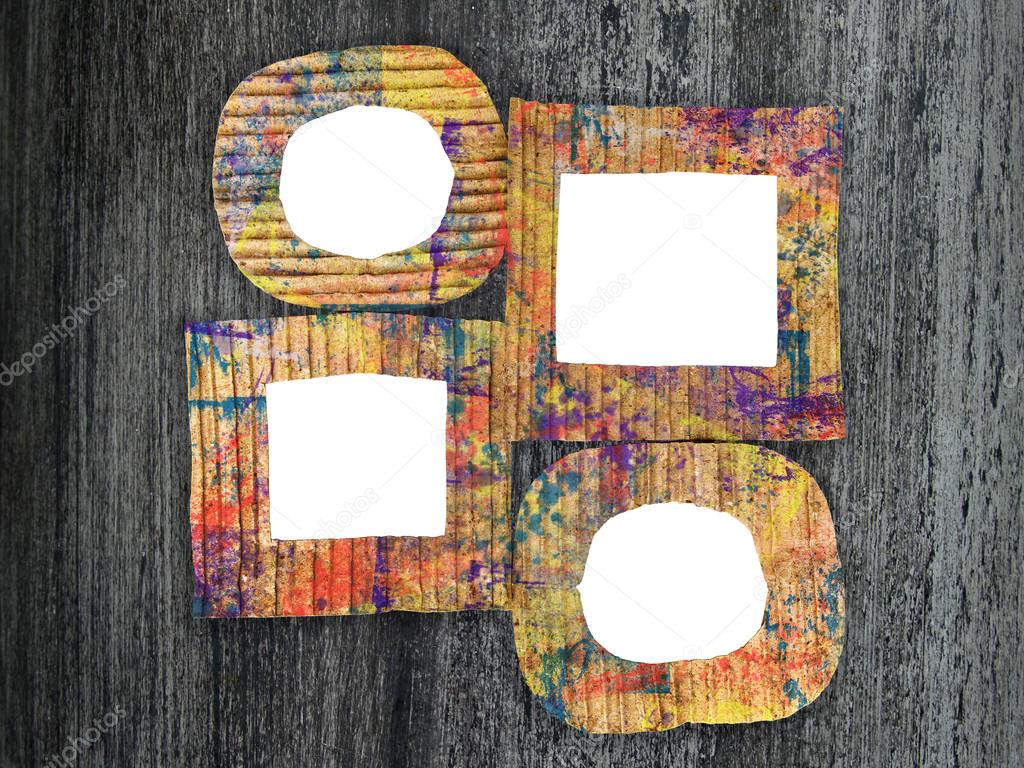Group of blank colorful painted cardboard frames on grunge background