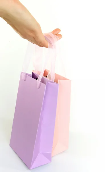 Hand holding colorful shopping bags isolated on white — Stock Photo, Image