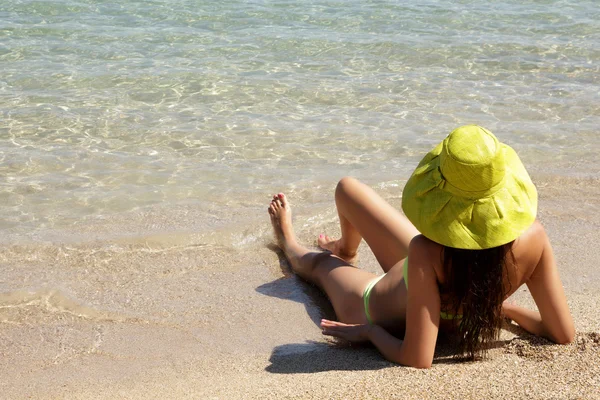 Young lady with hat on a sandy beach Royalty Free Stock Images