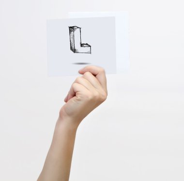 Hand holding a piece of paper with sketchy capital letter  L, isolated on white.