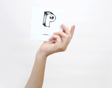 Hand holding a piece of paper with sketchy capital letter  P, isolated on white.