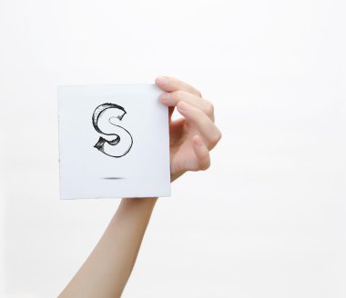 Hand holding a piece of paper with sketchy capital letter  S, isolated on white.