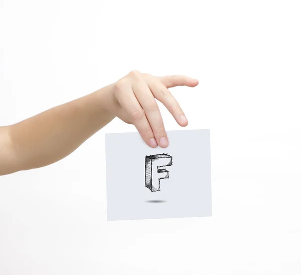 Hand holding a piece of paper with sketchy capital letter F, isolated on white. — Zdjęcie stockowe