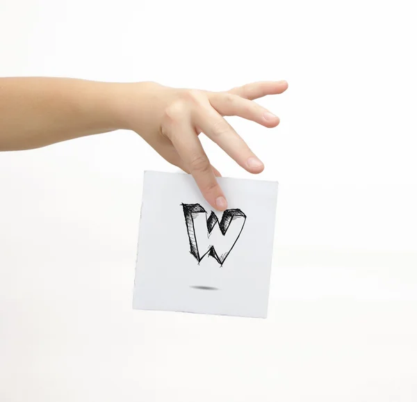 Hand holding a piece of paper with sketchy capital letter W, isolated on white. — 스톡 사진