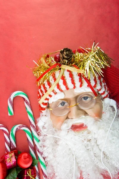 Santa with earphones, on red with Christmas ornaments — Stock Photo, Image