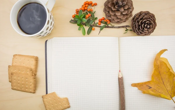 Notebook with cup of coffee autumn ornaments and cookies. — Stock Photo, Image
