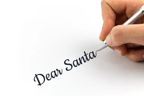 Hand writing "Dear Santa" on white sheet of paper. — Stock Photo, Image