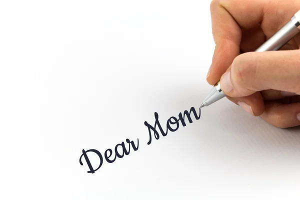 Hand writing "Dear Mom" on white sheet of paper. — Stock Photo, Image
