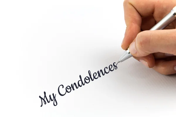 Hand writing "Condolences"  on white sheet of paper. — Stock Photo, Image