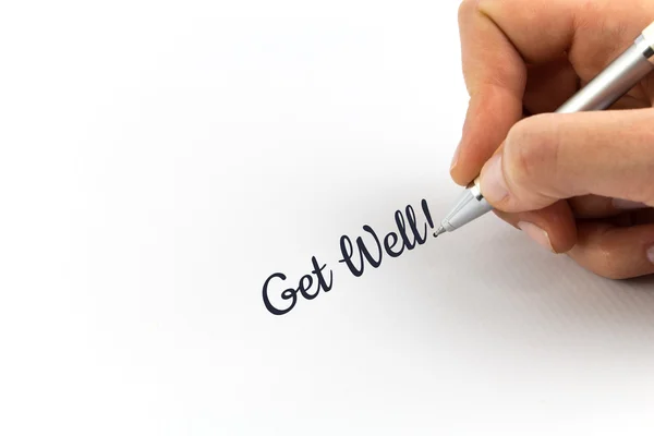 Hand schrijven "Get Well!" op wit vel papier. — Stockfoto