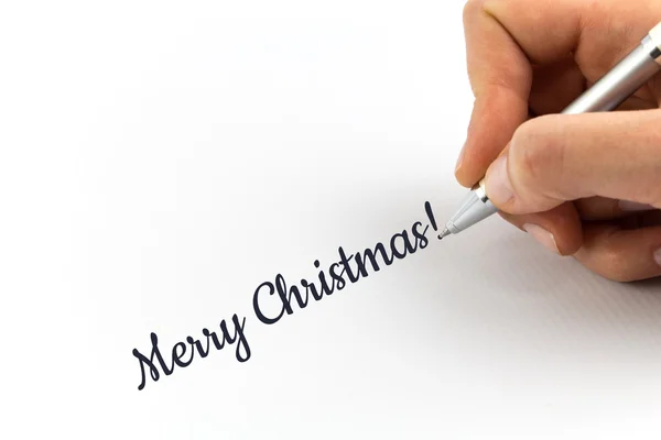 Hand writing "Merry Christmas!"  on white sheet of paper. — Stock Photo, Image