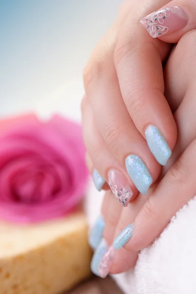 Fingernails with glitter blue and silver polish