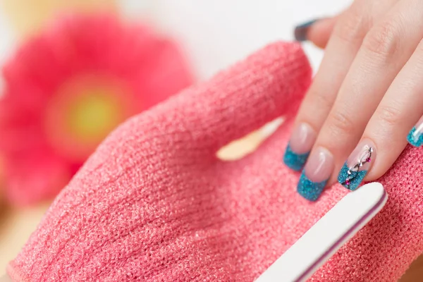 Woman having manicure treatment in salon