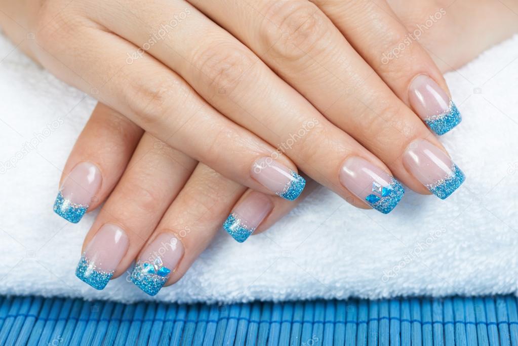 Fingernails with glitter blue and silver polish