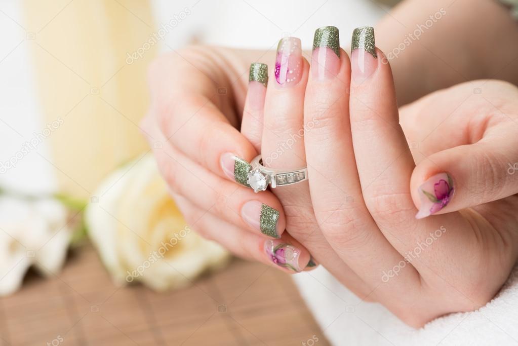 Manicured female hands with engagement ring