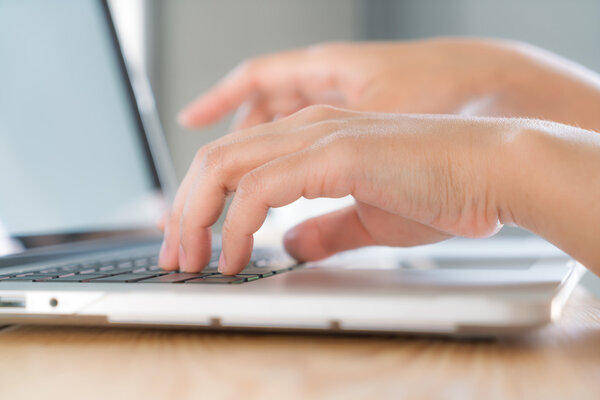 woman typing on keyboard