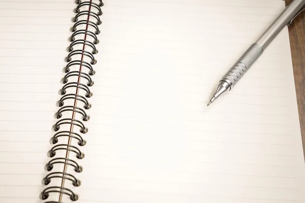 Notebook with pen on desk — Stock Photo, Image