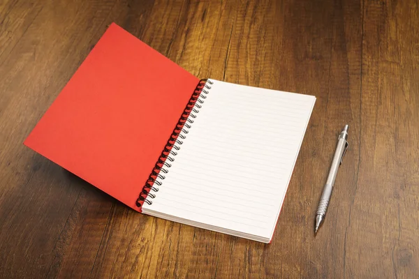 Notebook with pen on desk — Stock Photo, Image