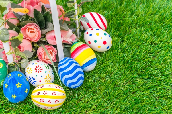 Easter eggs with artificial flowers — Stock Photo, Image