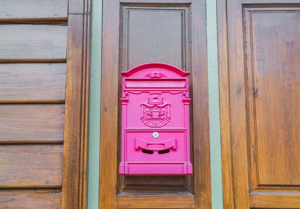 Red mail box on wood wall