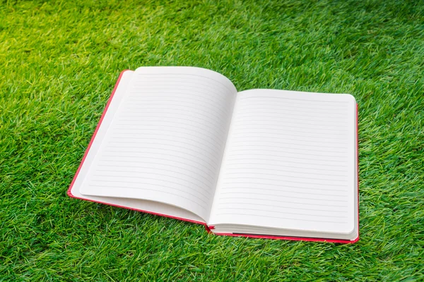 Notebook on spring green grass — Stock Photo, Image