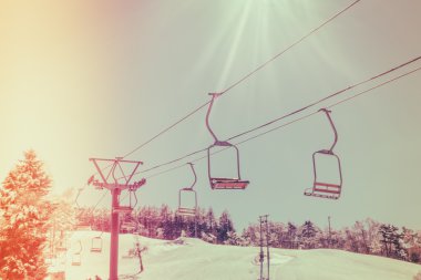 Sunset and  Ski lift going over the mountain ( Filtered image pr clipart