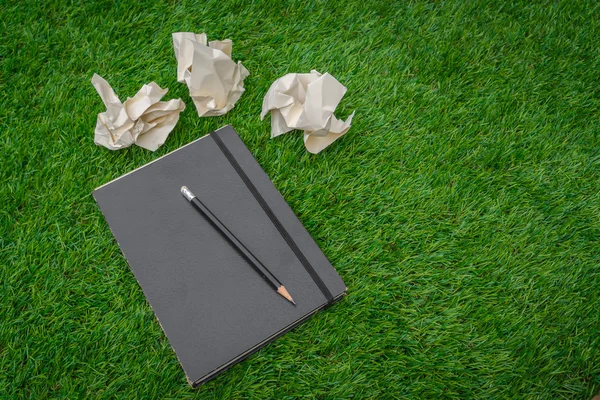 Notebook on spring green grass — Stock Photo, Image