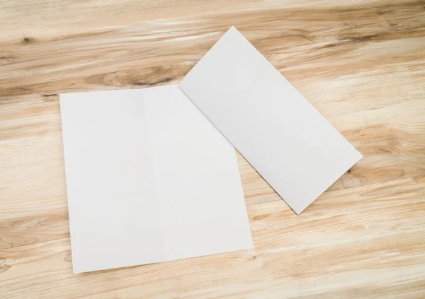 Papel modelo branco bifold na textura da madeira — Fotografia de Stock