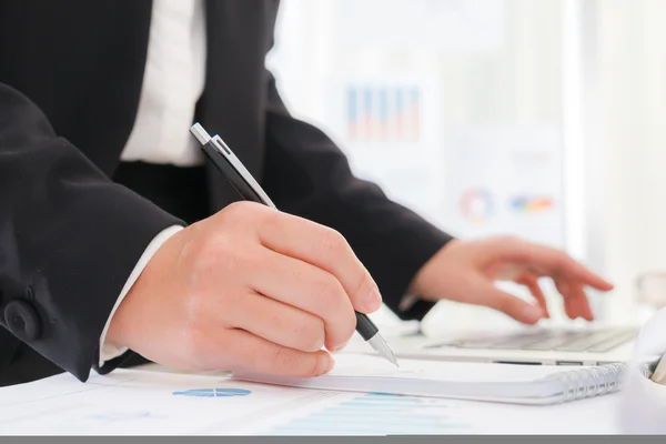 Business people using a pencil noting over laptop — Stock Photo, Image