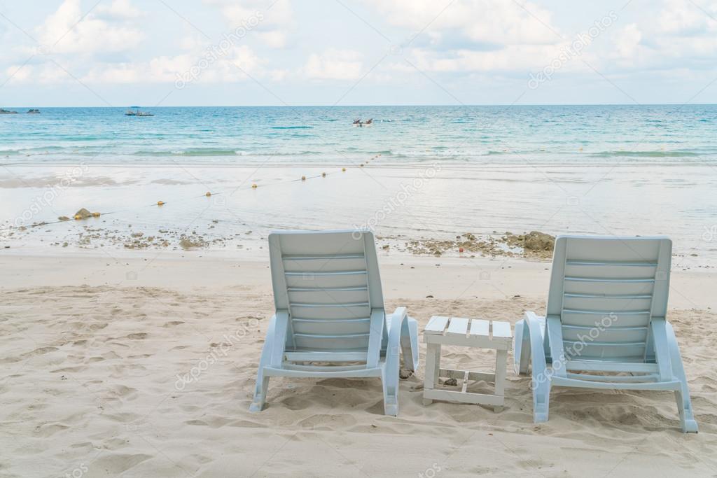 Beautiful beach chairs on tropical white sand beach