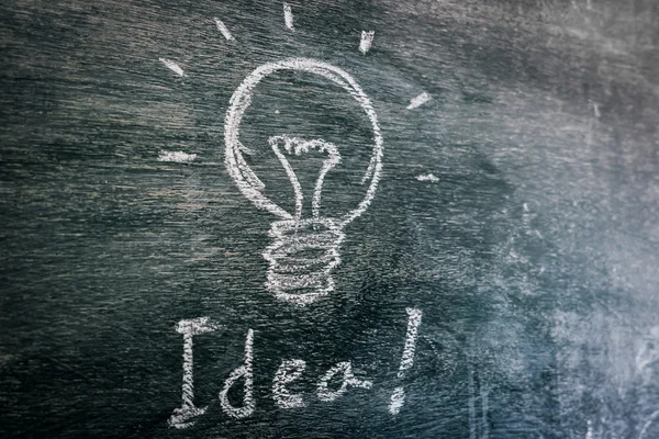 Light bulb for idea on Blackboard — Stock Photo, Image