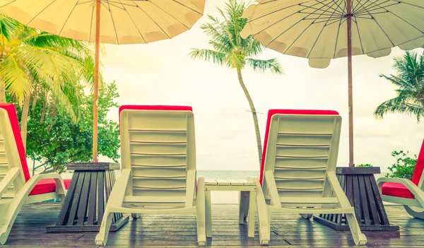 Vackra strandstolar med paraply runt utomhuspool bajs — Stockfoto