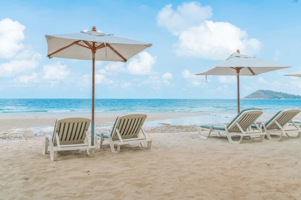 Beautiful beach chairs with umbrella on tropical white sand beac — Stock Photo, Image