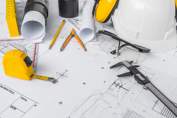 Planos de construção com capacete branco e ferramentas de desenho em bluepr — Fotografia de Stock