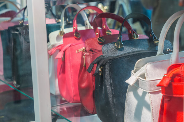Row of Ladies leather handbags .