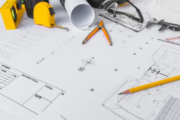 Construction plans with White helmet and drawing tools on bluepr Stock Photo