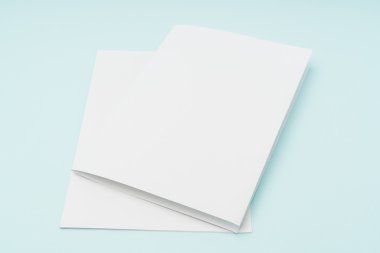 Bifold beyaz şablon kağıt üzerinde mavi arka plan .
