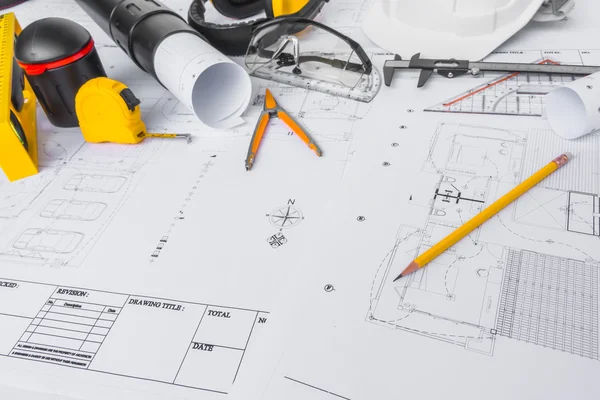 Construction plans with White helmet and drawing tools on bluepr — Stock Photo, Image