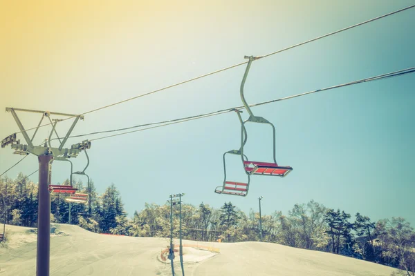 Sunset and  Ski lift going over the mountain ( Filtered image pr — Stock Photo, Image