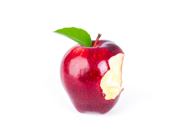 Red apple with green leaf and missing a bite . — Stock Photo, Image