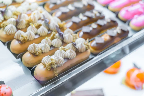 Brightly colored cakes  in refrigerator . — Stock Photo, Image