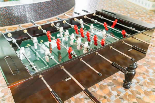 Football table game with red and white player .