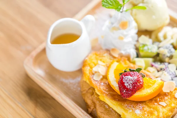 French toast with powdered sugar and a strawberry on wood table — Stock Photo, Image