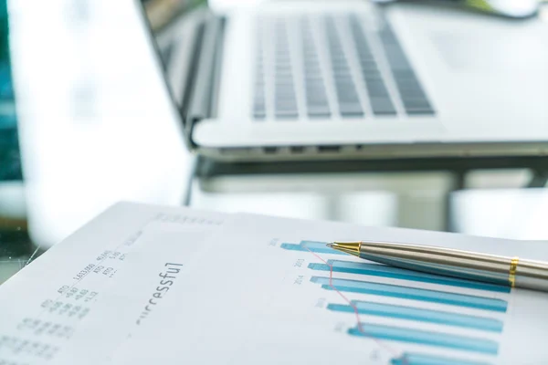 Financial charts on the table with laptop . — Stock Photo, Image