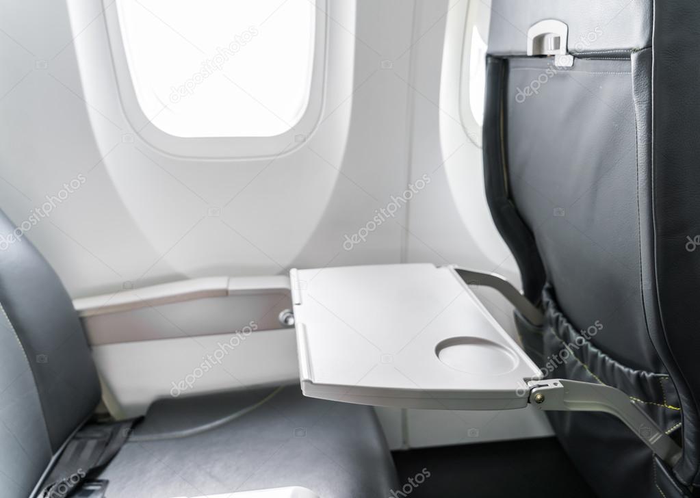 Airplane tray table on seat back .